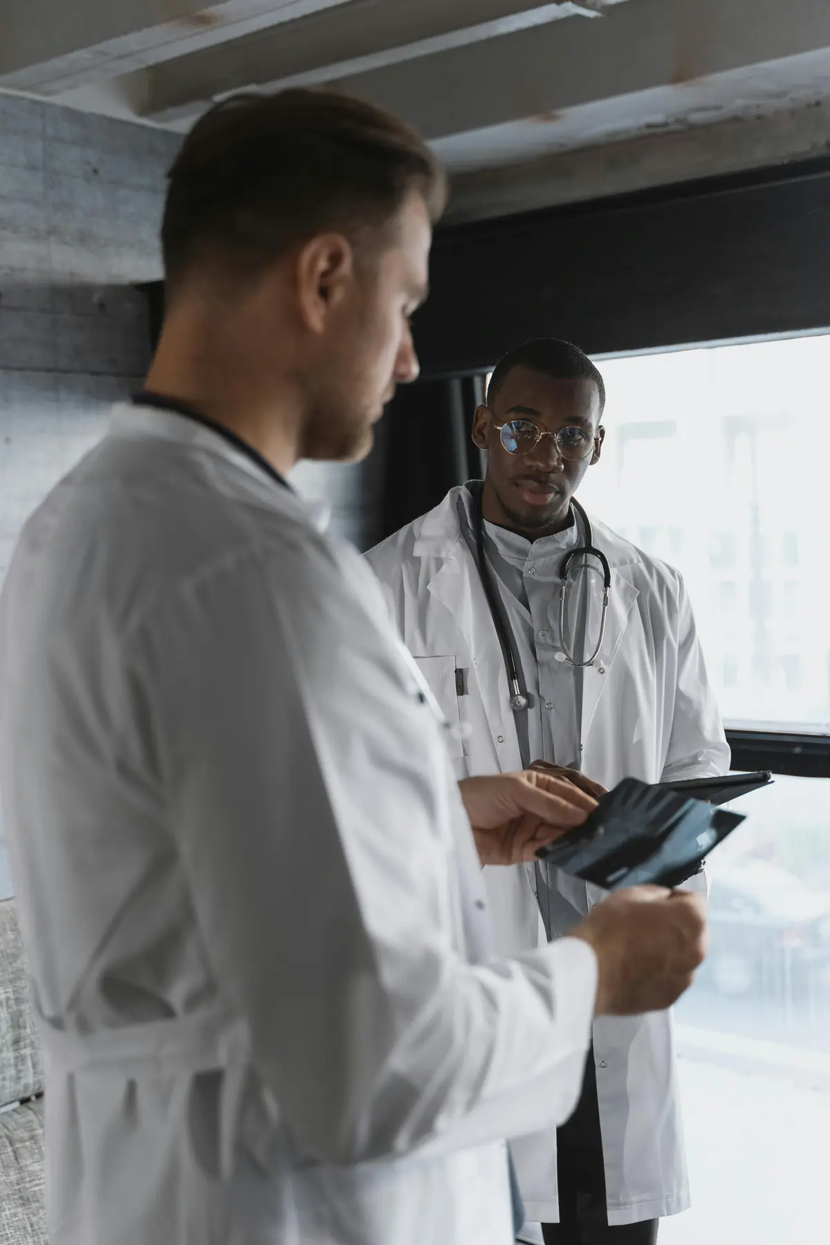 Two scientists reviewing results on a tablet